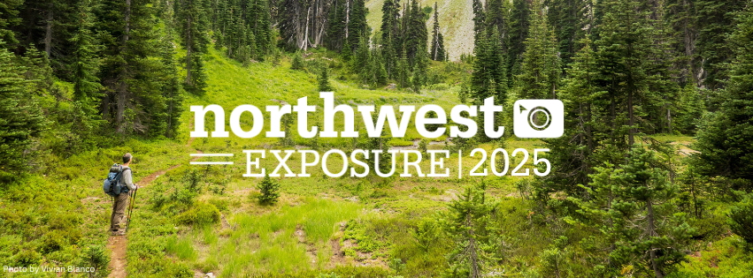 Hiker with backpack looks toward winding green trail in background. Northwest Exposure 2025 logo in white in center of image.
