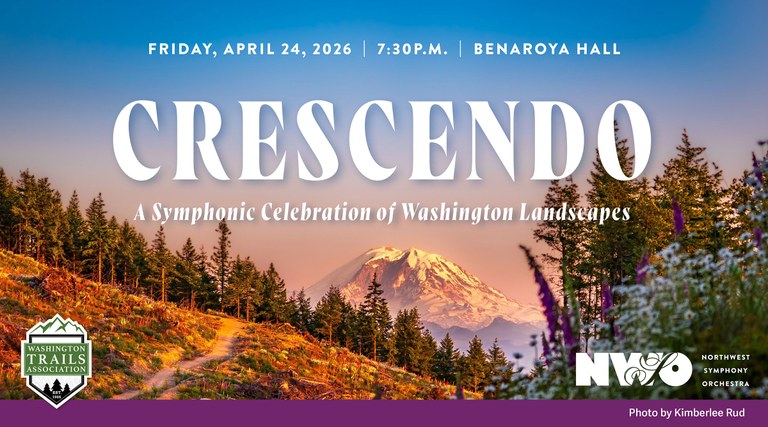 Image: A field of white and purple flowers fills the front right corner of the photo. A thin dirt trail winds to the left of the flowers and into the distance, where Mt. Rainier fills the center of the photo. Photo by Kimberlee Rud.Text: Crescendo: A Symphonic Celebration of Washington Landscapes. Benaroya Hall. Friday, April 24. 7:30 p.m.
