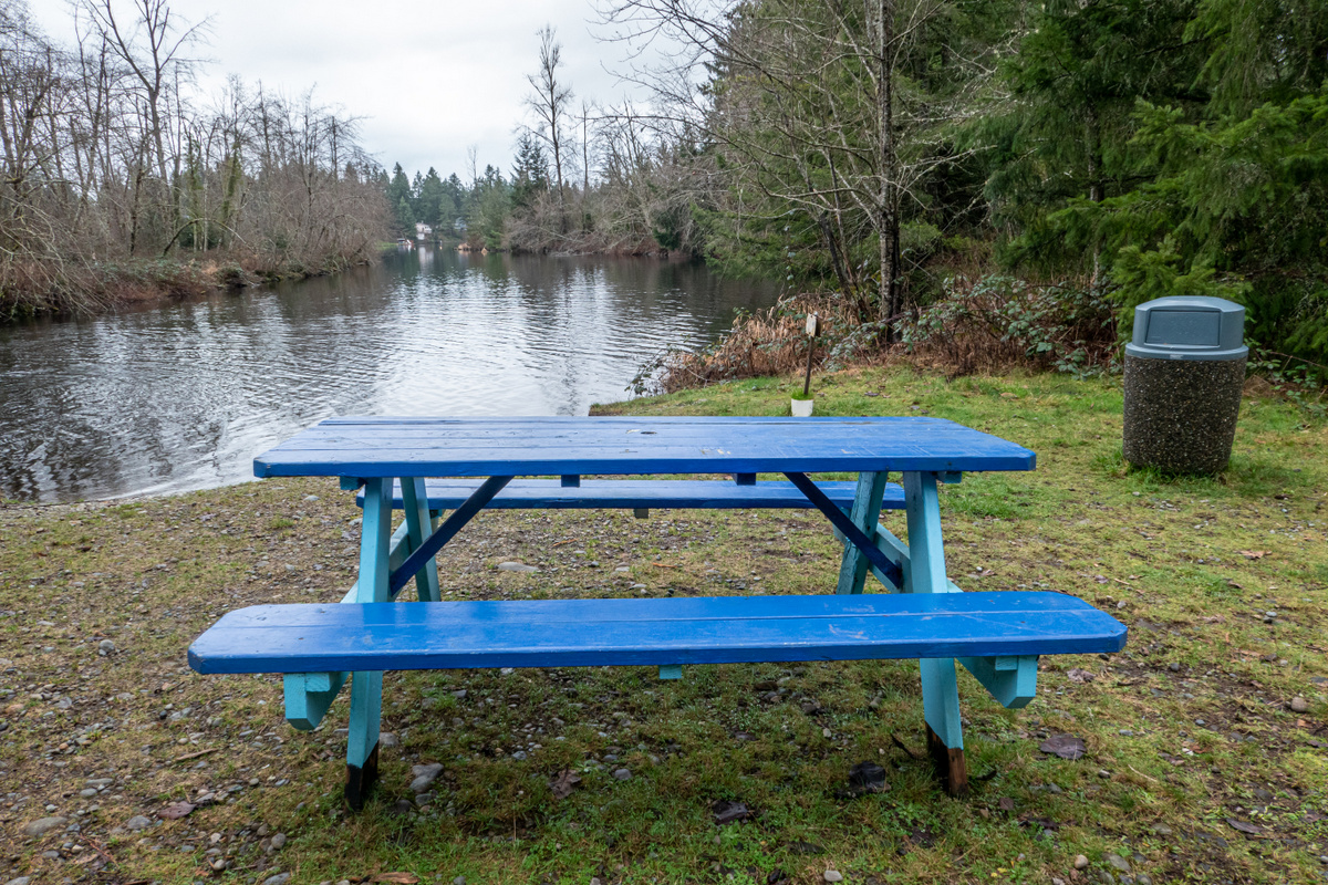 Blue picnic table next to the water at Black Diamond Open Space. Photo by ejain.