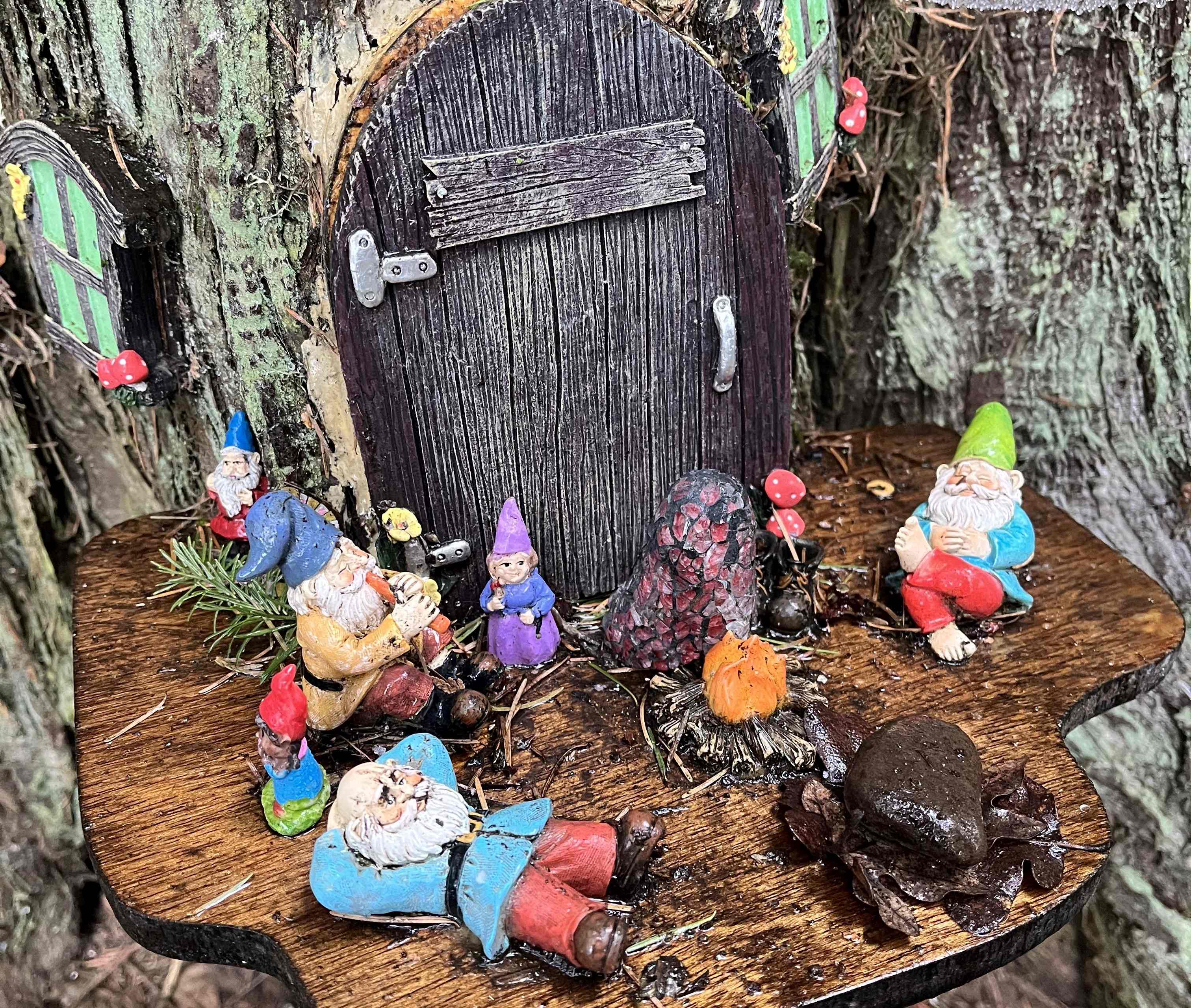Gnome village on the Burnt Bridge Creek trail. Photo by Mini_meanderer. Small gnome village with colorful gnomes, a small door and window and mushroom decorations on the Burnt Bridge Creek trail. Photo by Mini_meanderer.