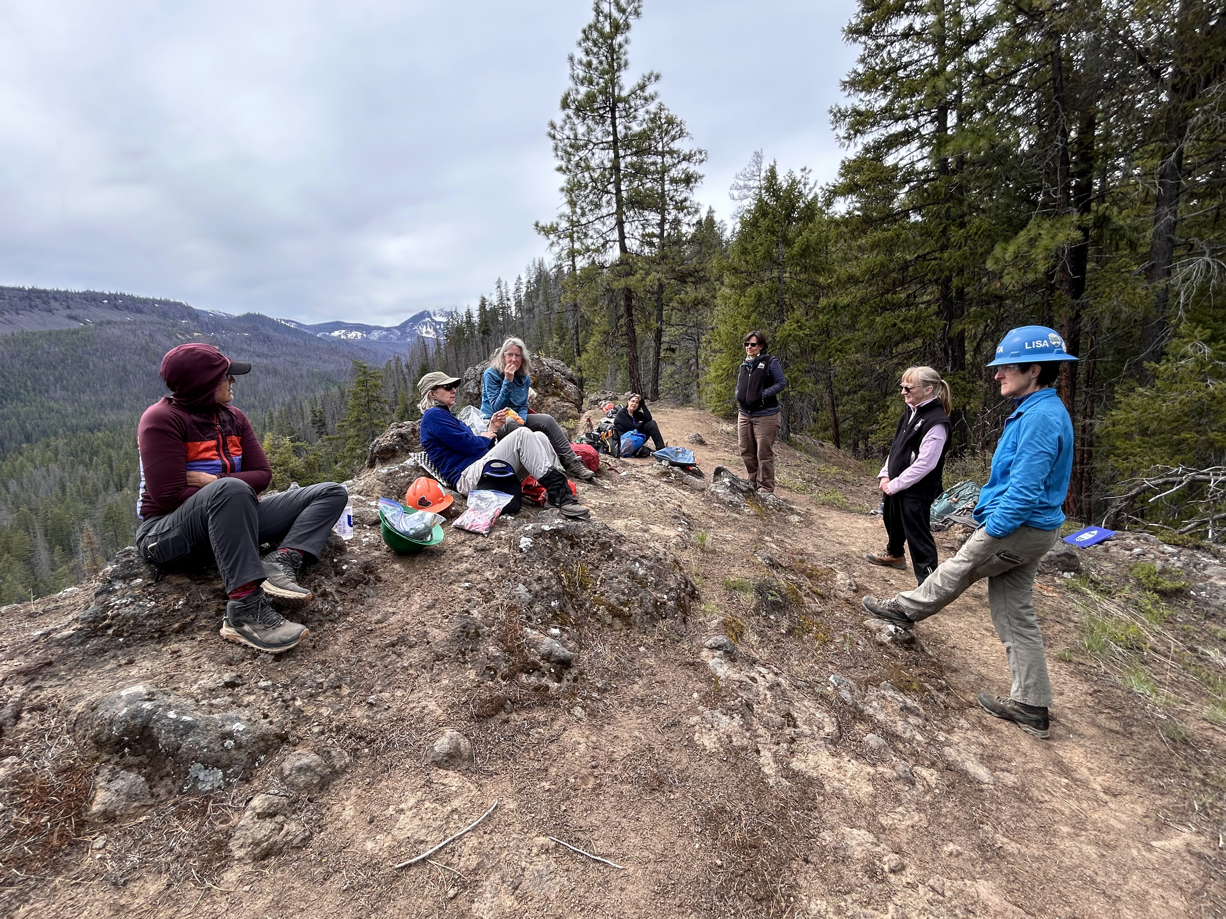 Women reset along trail ridge line.