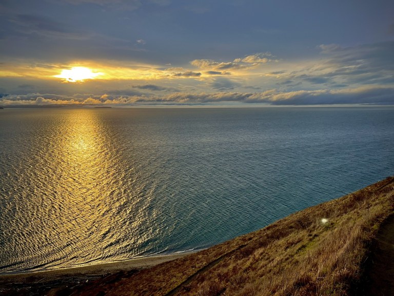 The sunset colors over the Puget Sound on the Ebey's Landing trail. Photo by trip reporter RKiser.