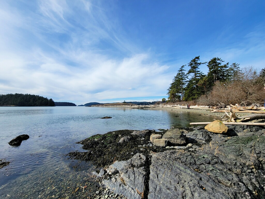 Rocky beach at Kukutali Preserve on a sunny day. Photo by kokay.