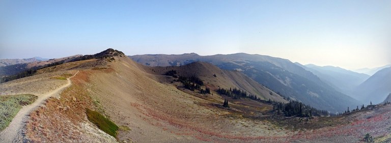 Lillian Ridge view An expansive panorama of a fall-color strewn ridgeline with mountains in the distance.