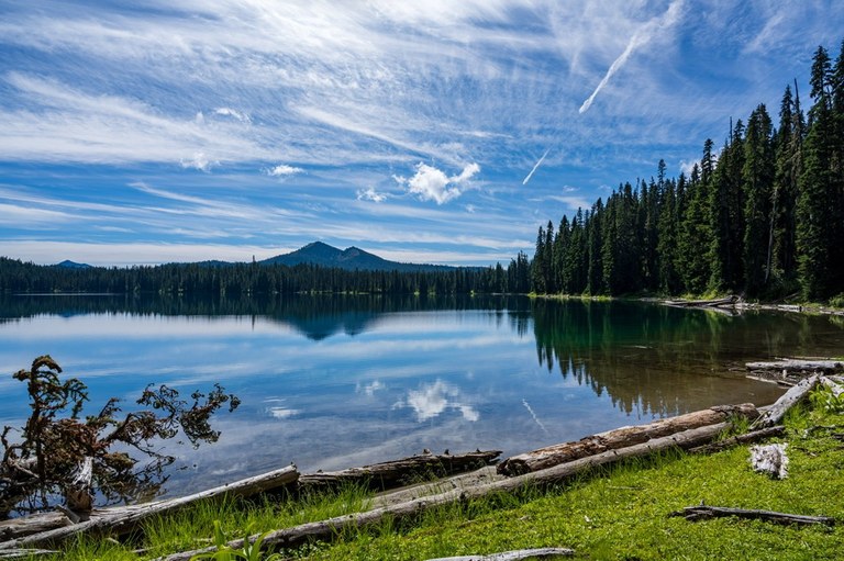 Twin Sisters Lakes Photo of a lake with a mountain in the distance and trees to one side