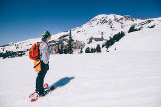 A hiker stands in the snow.