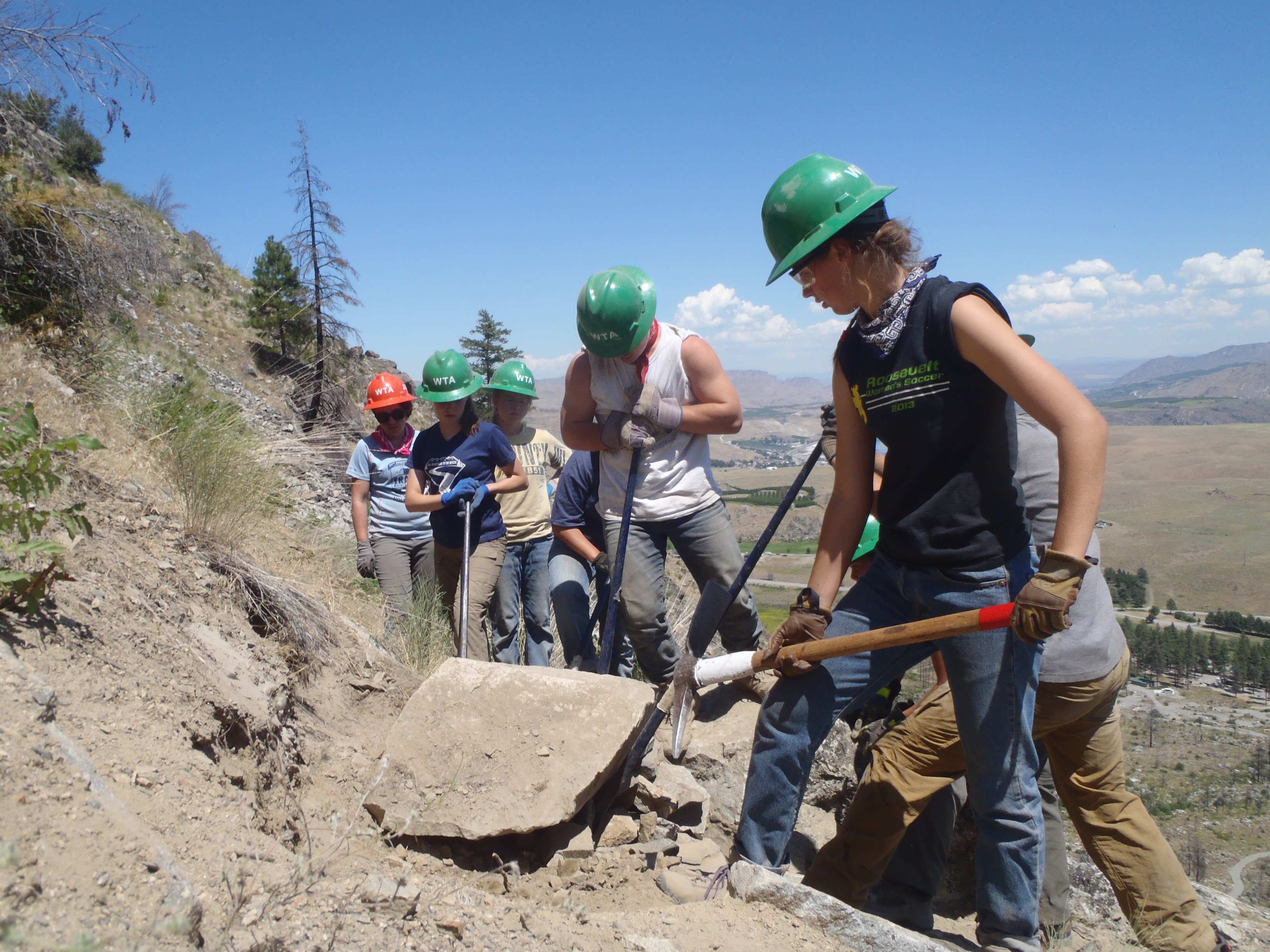 Crew moving large boulder.jpg
