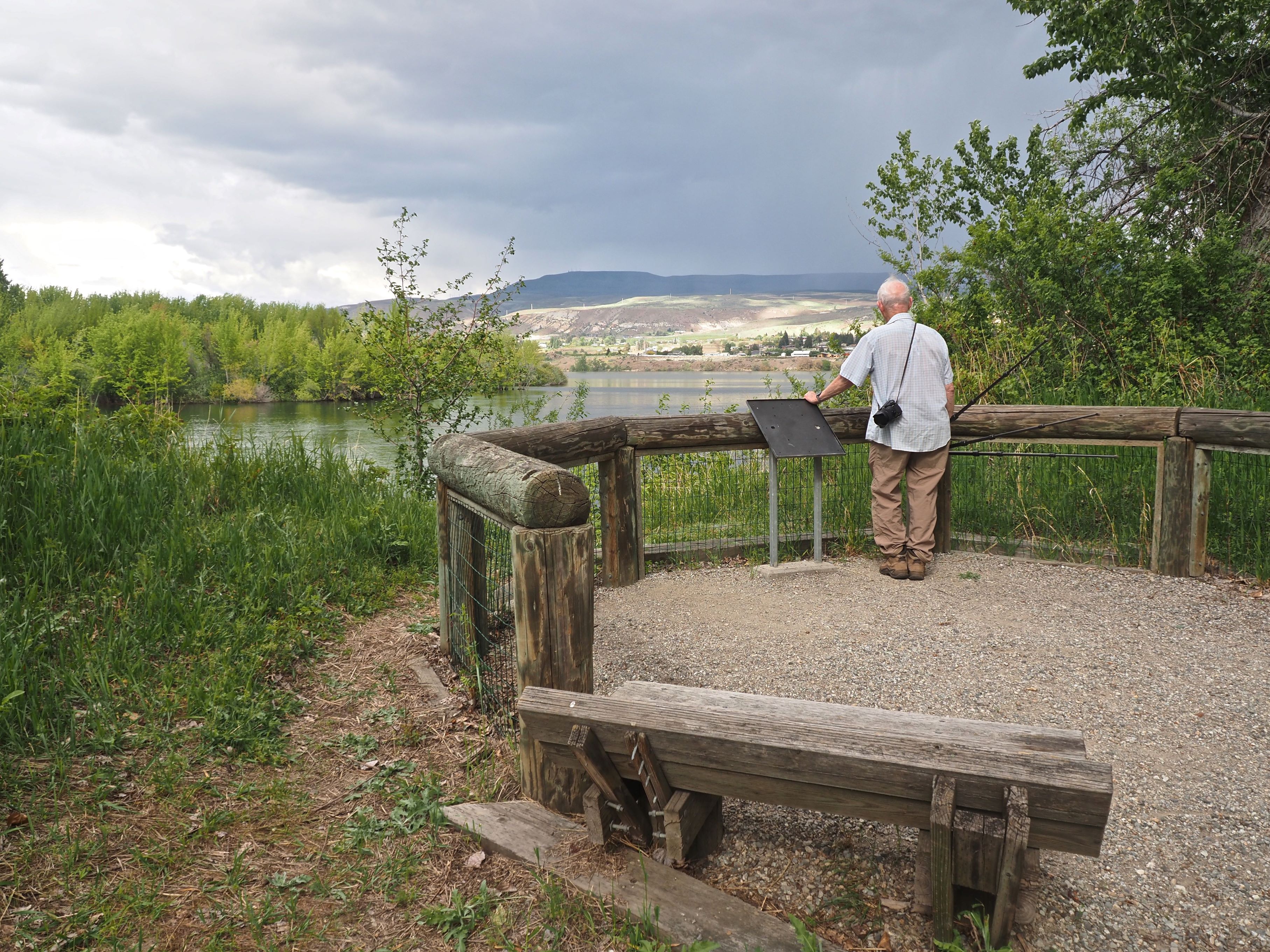Wenatchee Confluence State Park - Horan Natural Area. Photo by Bob and Barb. Man stands at a viewing platform overlooking the water at Wenatchee Confluence State Park - Horan Natural Area. Photo by Bob and Barb.