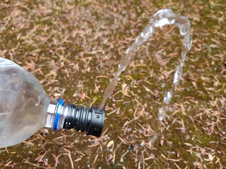 Each nozzle has a different pressure level and trajectory. Choose wisely and practice at home. Photo by Joseph Gonzalez A black bidet attachment shoots water from an upside down water bottle.