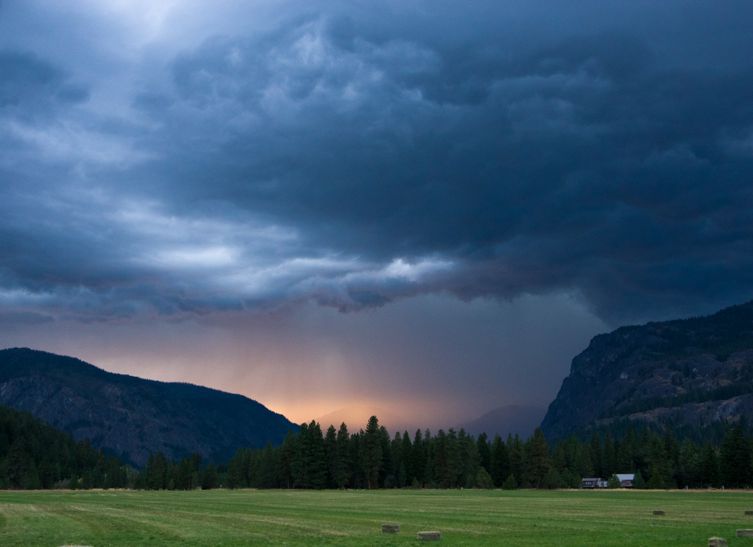 Thunder storm over green meadow