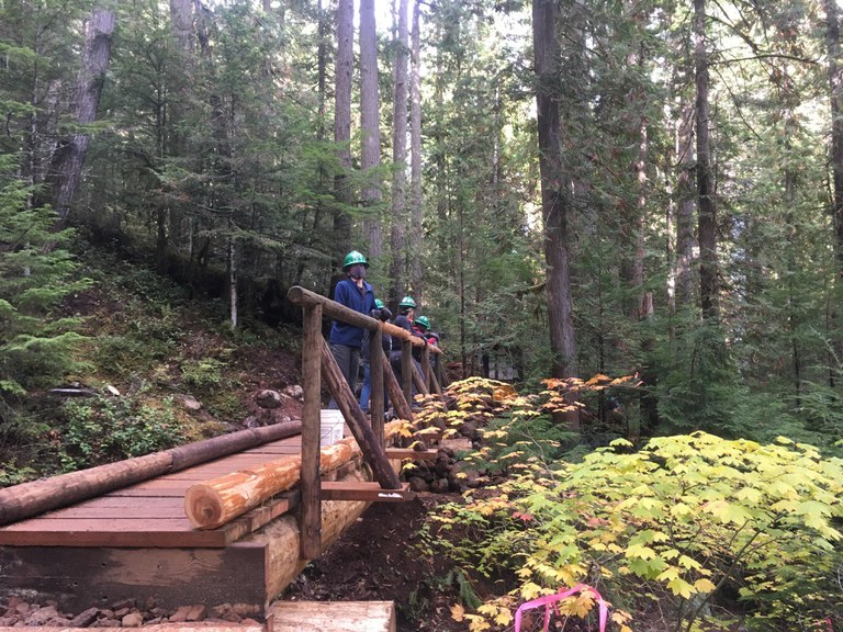 The newly-replaced Lena Lake Bridge and several volunteers standing on it. Photob y Charlie Romine. 
