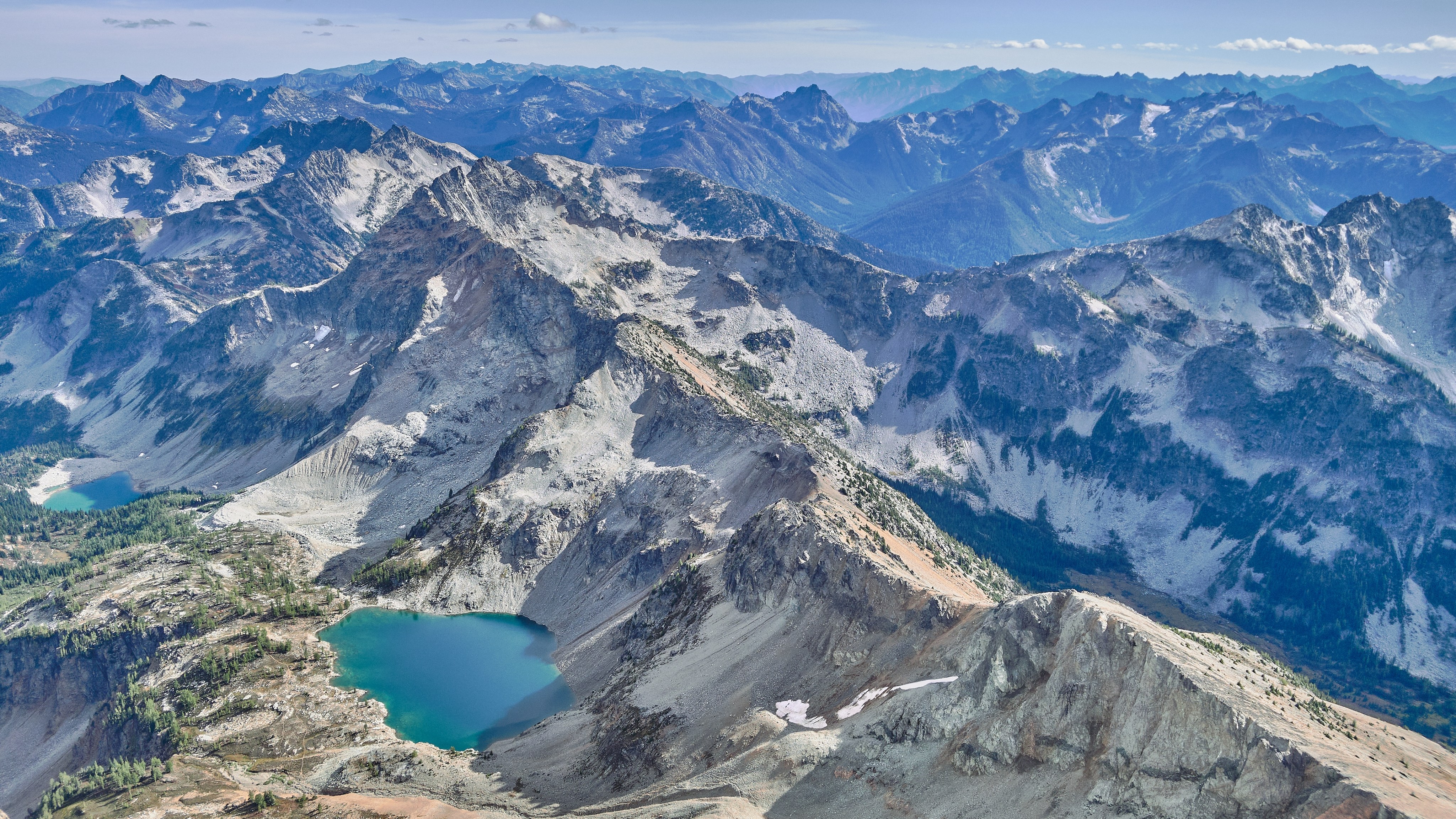 Layers of mountainous peaks with lakes nestled in between