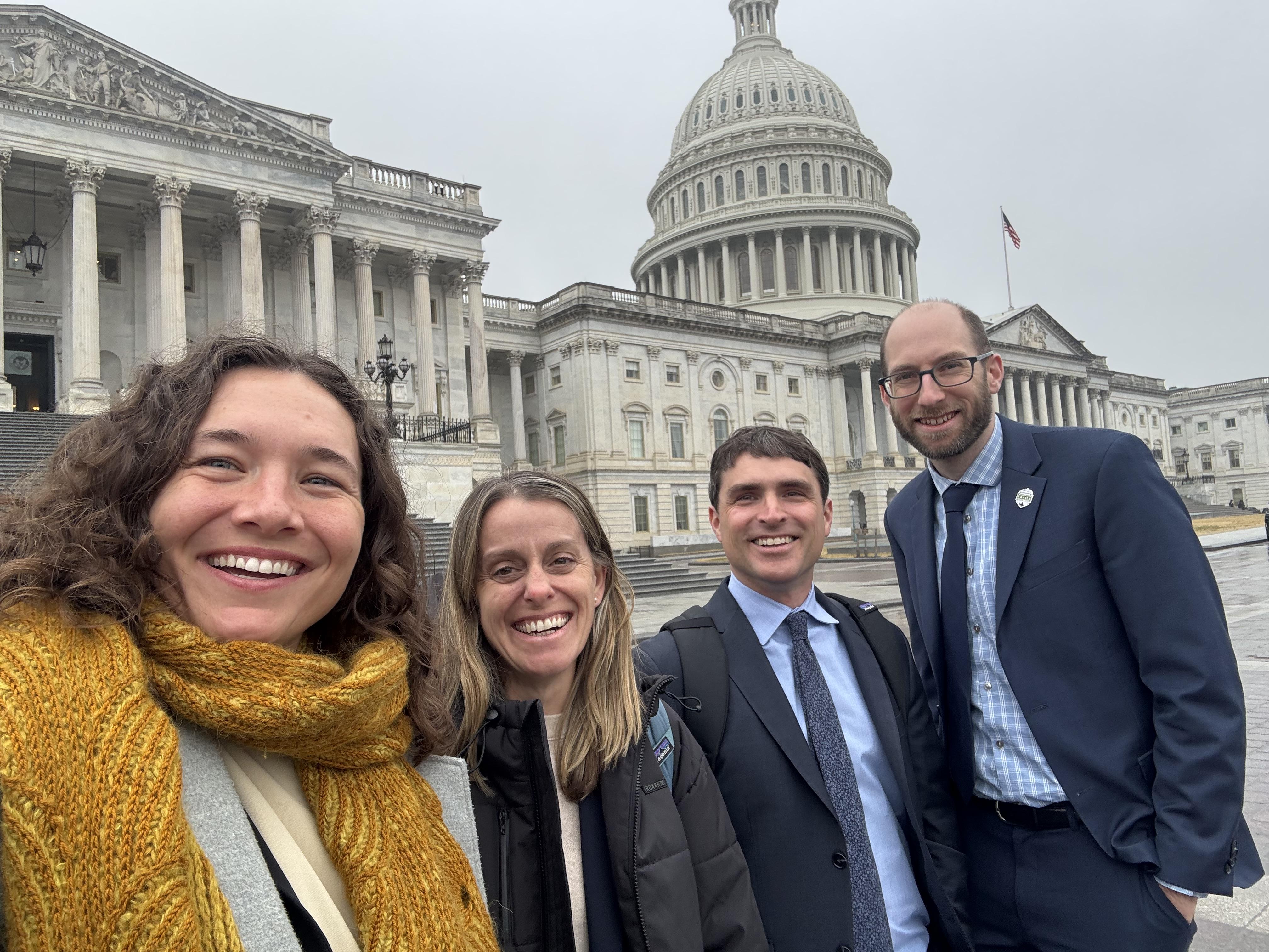 Four recreation advocates including a staff member from WTA stand in front of the US Capitol in Washington D.C.