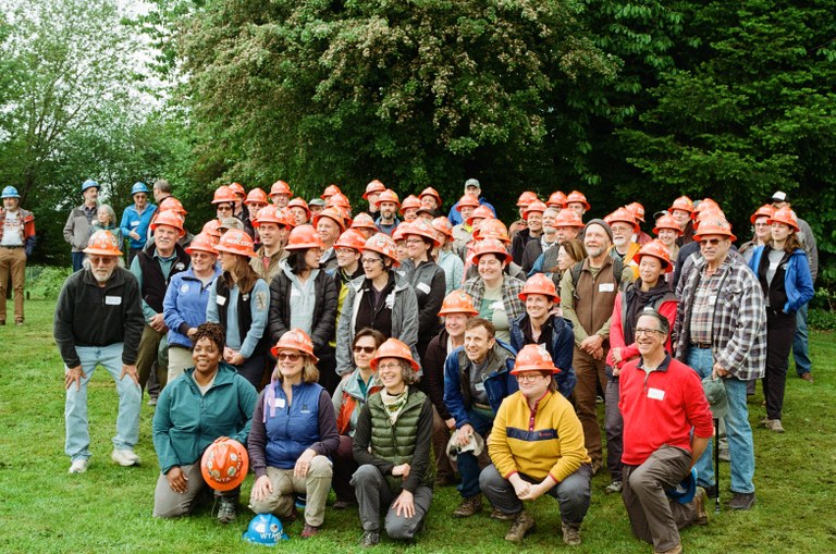 A collection of WTA orange hats, or assistant crew leaders, congregate at a training.