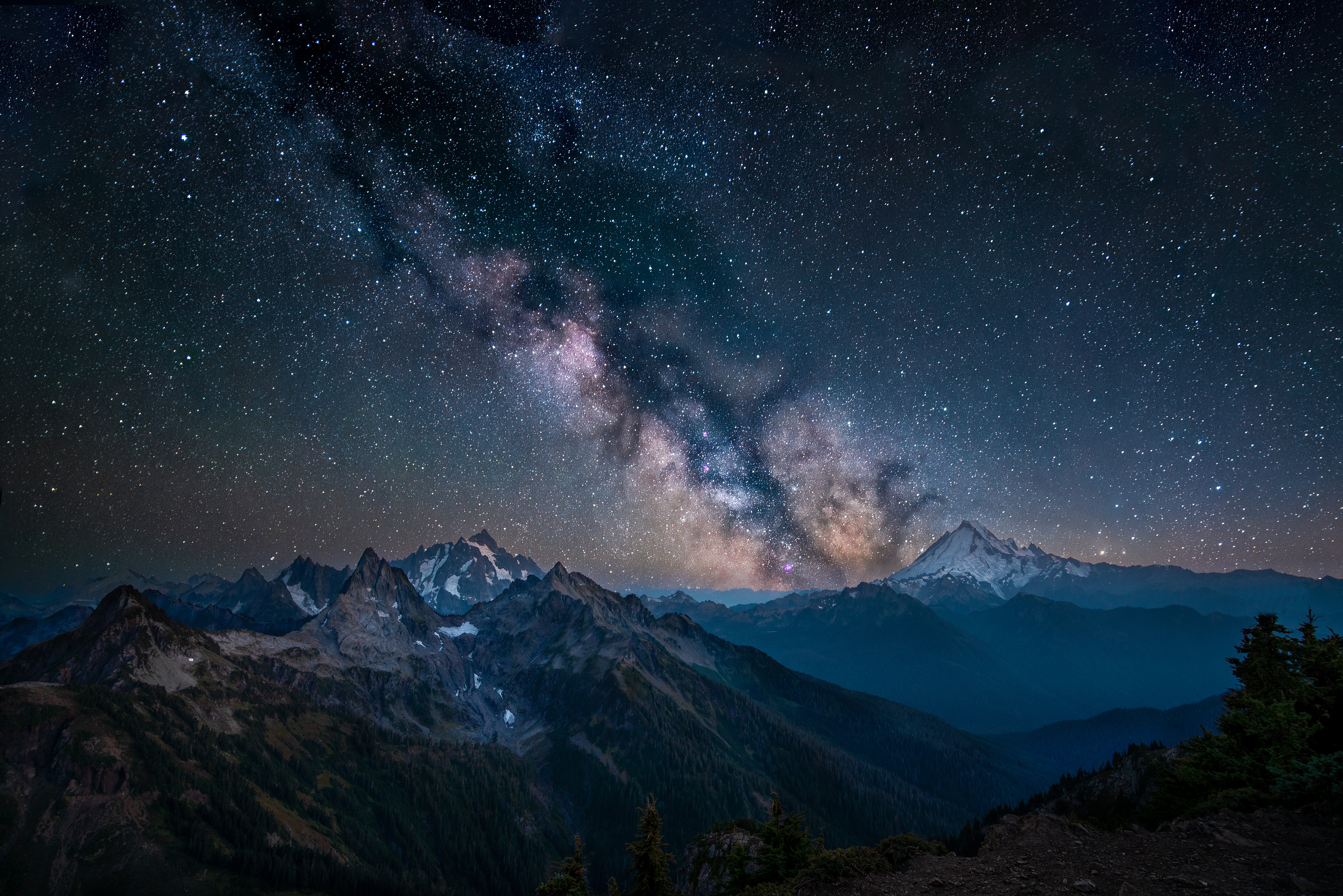 2nd trailscapes 2024 Kevin Rabuck The Milkyway stretches across the night sky with jagged peaks in the foreground.