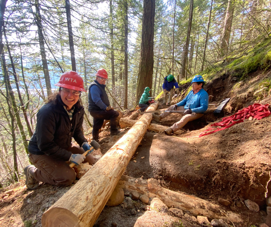 A group of trail maintainers build a crib wall.
