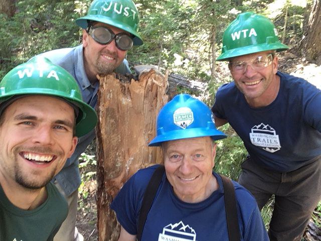 Bob Cowdrick (right) had such a good time on his first BCRT learning from crew leader Gary Zink (front, center), he returned every year to spend another week gaining wisdom and skills. Photo by Bob Cowdrick Four volunteers take a selfie from trail.