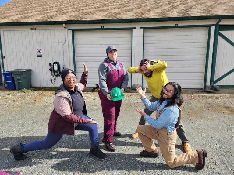 Angelic, Jay and Zachary celebrate Crystal, who is holding her green hat.