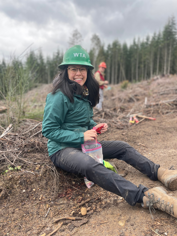 A green hat enjoys a snack on trail.