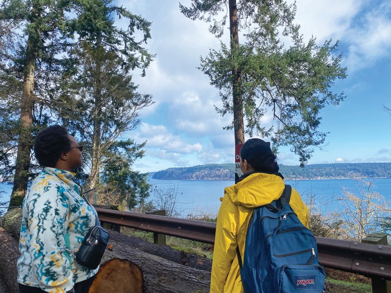 Reflecting on a day of community from Point Defiance State Park. Photo by MJ Sampang Two hikers gaze out over the Puget Sound.