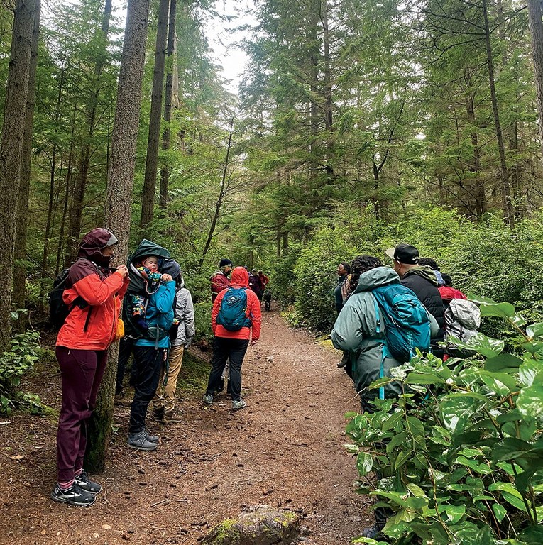 Creating opportunities for time with industry professionals — like a community hike — is a cornerstone of the Emerging Leaders Program. Photo by MJ Sampang The ELP cohort and community partners hike on a rainy day.