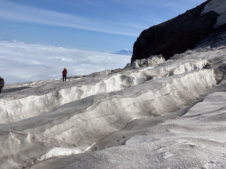 A climber walks along a glacier on Mount Rainier