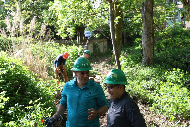 WTA CEO Jaime Loucky and King County Parks Director Warren Jimenez chat with one another at a WTA work party.
