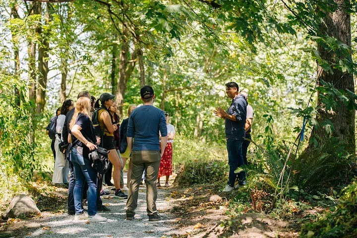 WTA CEO Jaime Loucky speaks to hikers on a trail.
