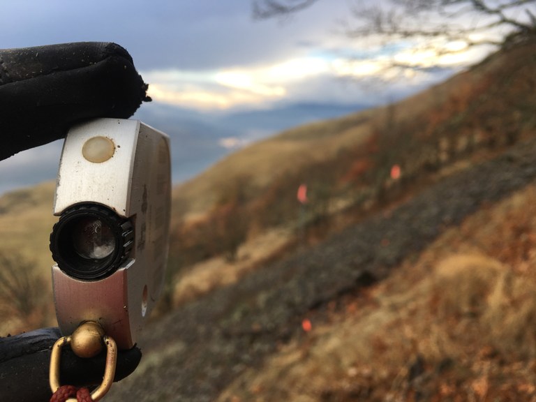 Clinometer Ryan holds a clinometer up to view the grade of a proposed trail reroute.