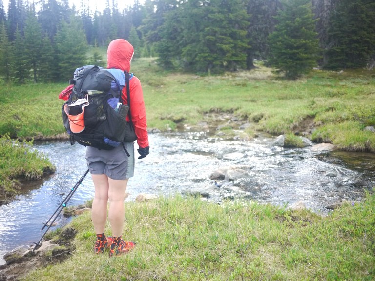 Andrea scouts a stream crossing. Photo by Todd Schneider.