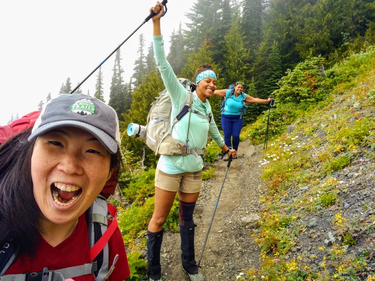 Charlie and friends smiling during a hike.