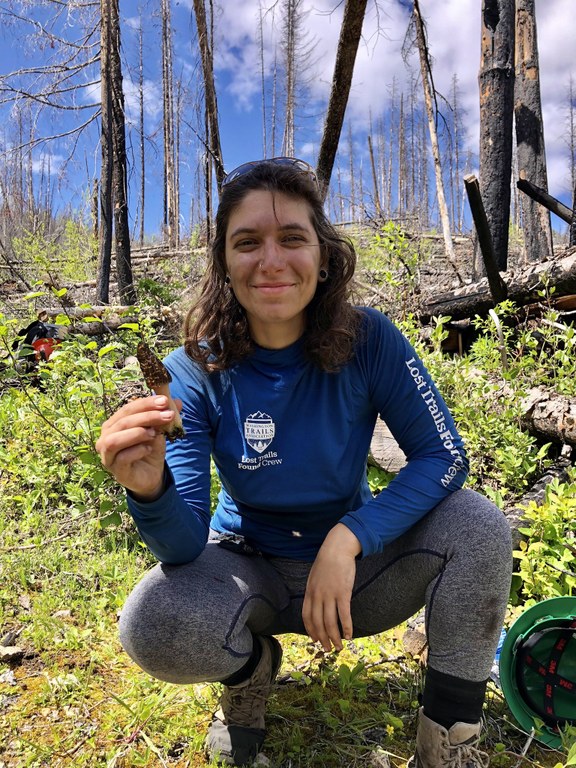 Iman holds a morel mushroom found while sawing logs in an old burn area.