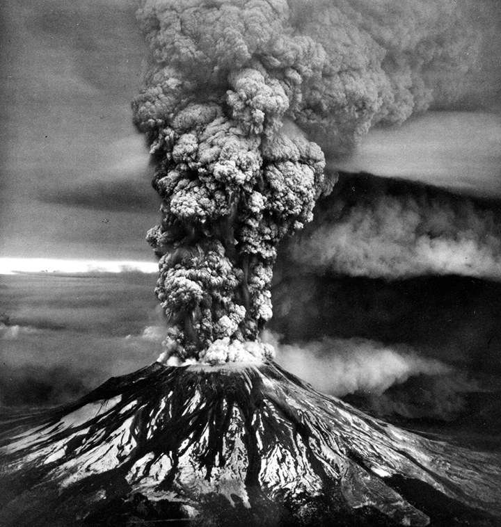 Iconic black and white photo of a plume of ash rising high about Mount St. Helens. 