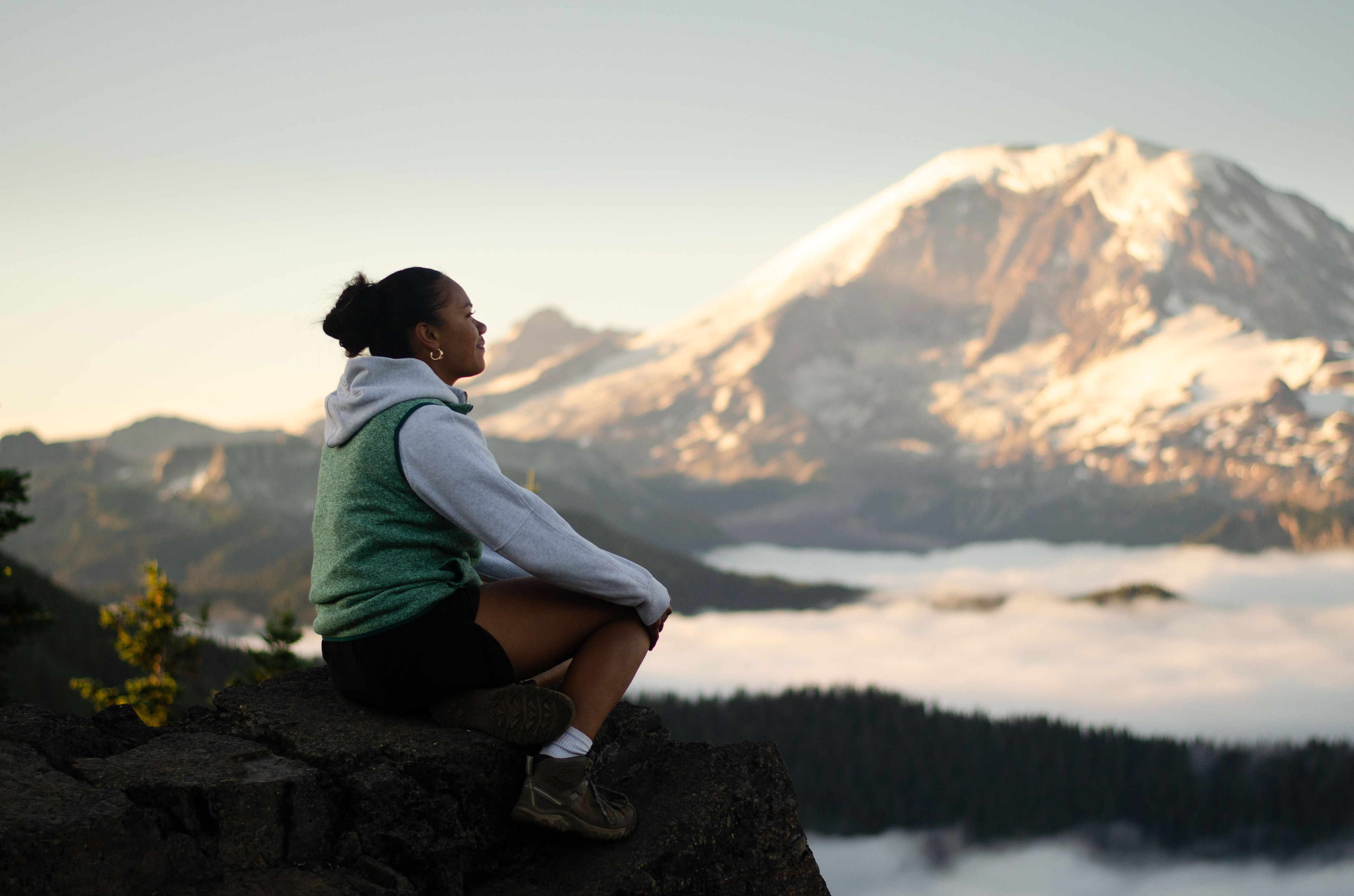 Hikers in Action 2nd place photo by Emmett C toddler on bridge in center of frame balances giant camera and lens while shooting a subject off frame to the right hand side.