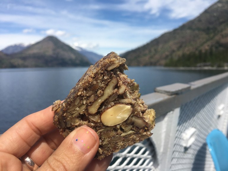 A slice of stone age bread held by a hike on a boat.