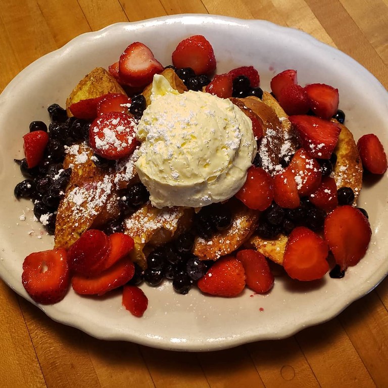 Homemade Maltby bread fruit French toast with fresh strawberries and blueberries