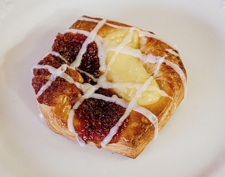 A beautiful Danish pastry sits on a plate.