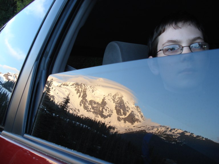 A passenger looks at a mountian through a car window. Photo by Michelle Gephart. 