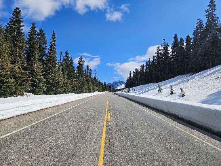 The North Cascades Highway (Highway 20) with snowbanks on the side, photo from April 11, 2025. Photo courtesy of the Washington State Department of Transportation.