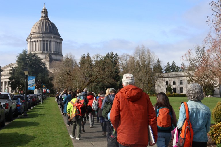 Hikers walk toward the state capitol. 