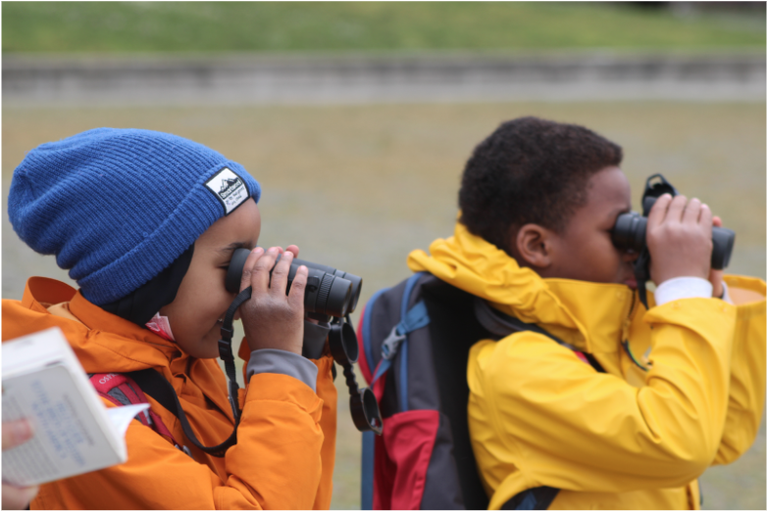 ACHD Two youths use binoculars.