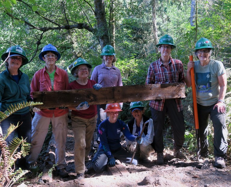 An all-women's crew poses with a piece of bridge they were removing at Deception Pass State Park. Photo by Linda Roe.