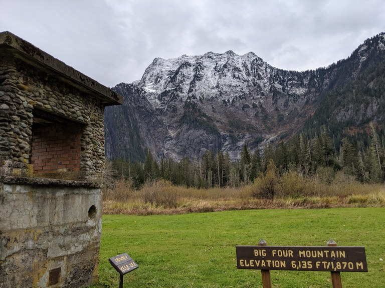 Big Four rises behind a sign reading "Big Four Mountain, elevation 6,135 feet.