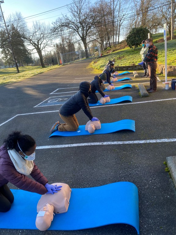 Participants in a BIPOC-centered WFA course learning how to do CPR on dummies. Photo courtesy of Braided Seeds.