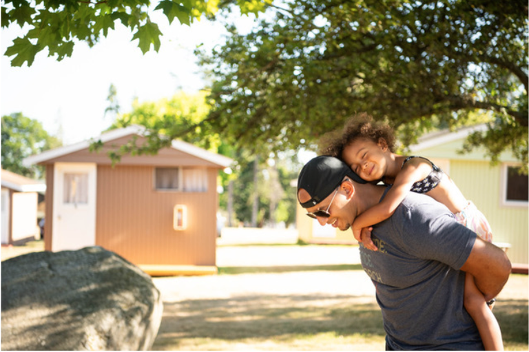 Bronze Chapter An adult carrying a child piggyback.