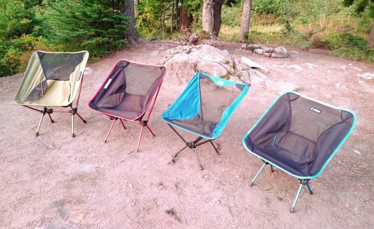 Four empty camp chairs in a row.