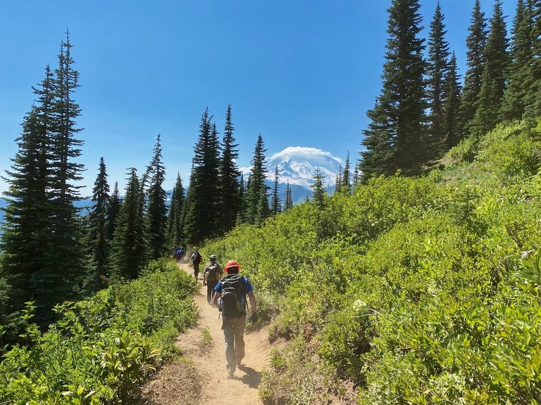 Mount Rainier trail crew. Photo by Dan Hagberg.  A WTA trail crew hiking on the trail with Mount Rainier in the background. Photo by Dan Hagberg.