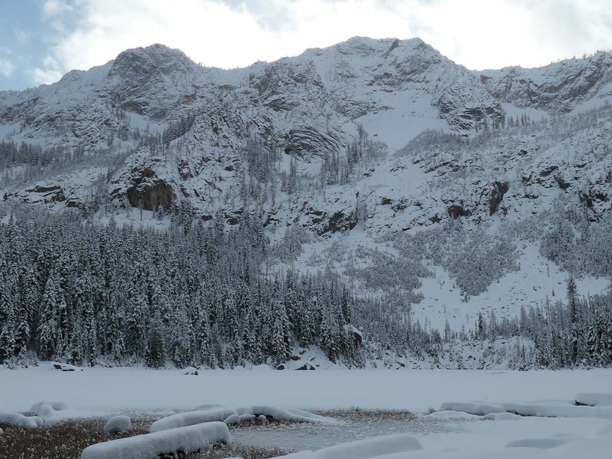 A snowy Cutthroat Lake with snowy mountain peaks. Photo by Rolan Shomber.