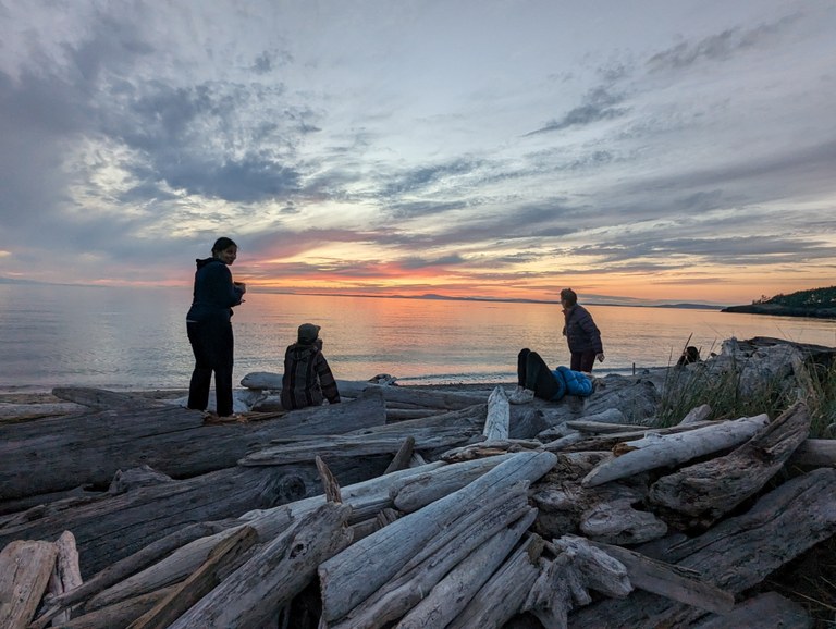 A group of crew members watch the sunset on the water on a volunteer vacation at Deception Pass. Photo by Karin Plagens.