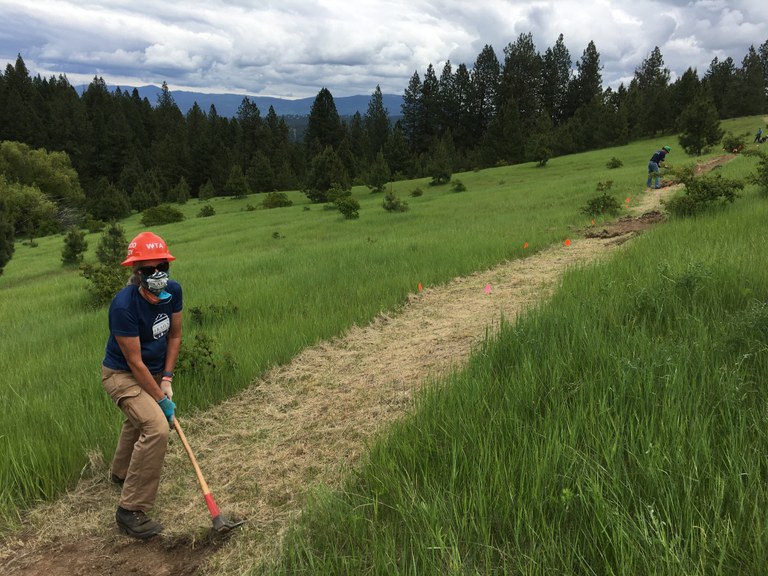 Volunteer Smiles during Philips Creek New Trail Construction
